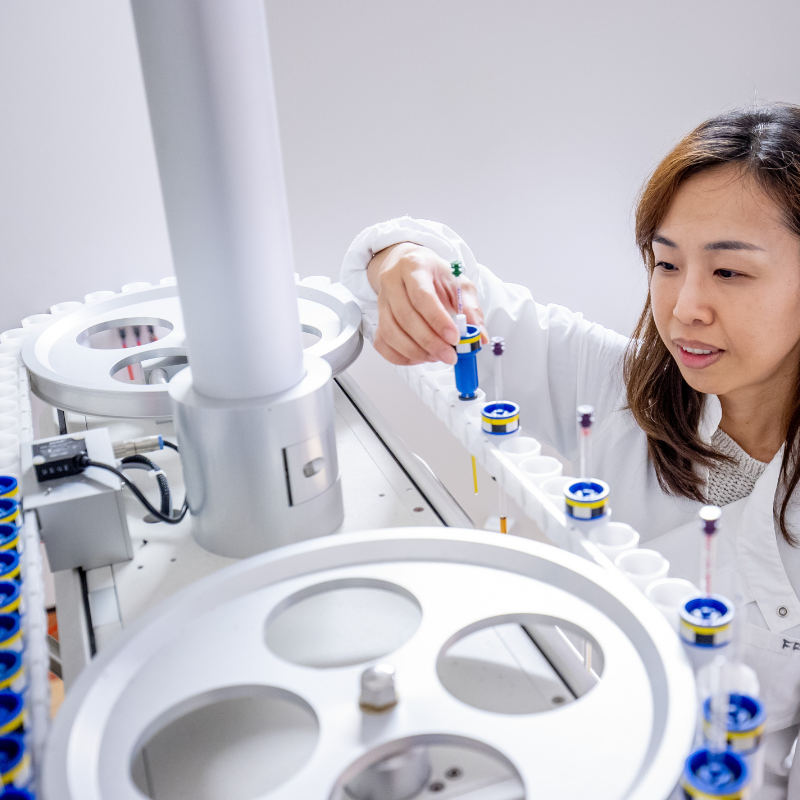 Woman loading samples into an instrument carousel